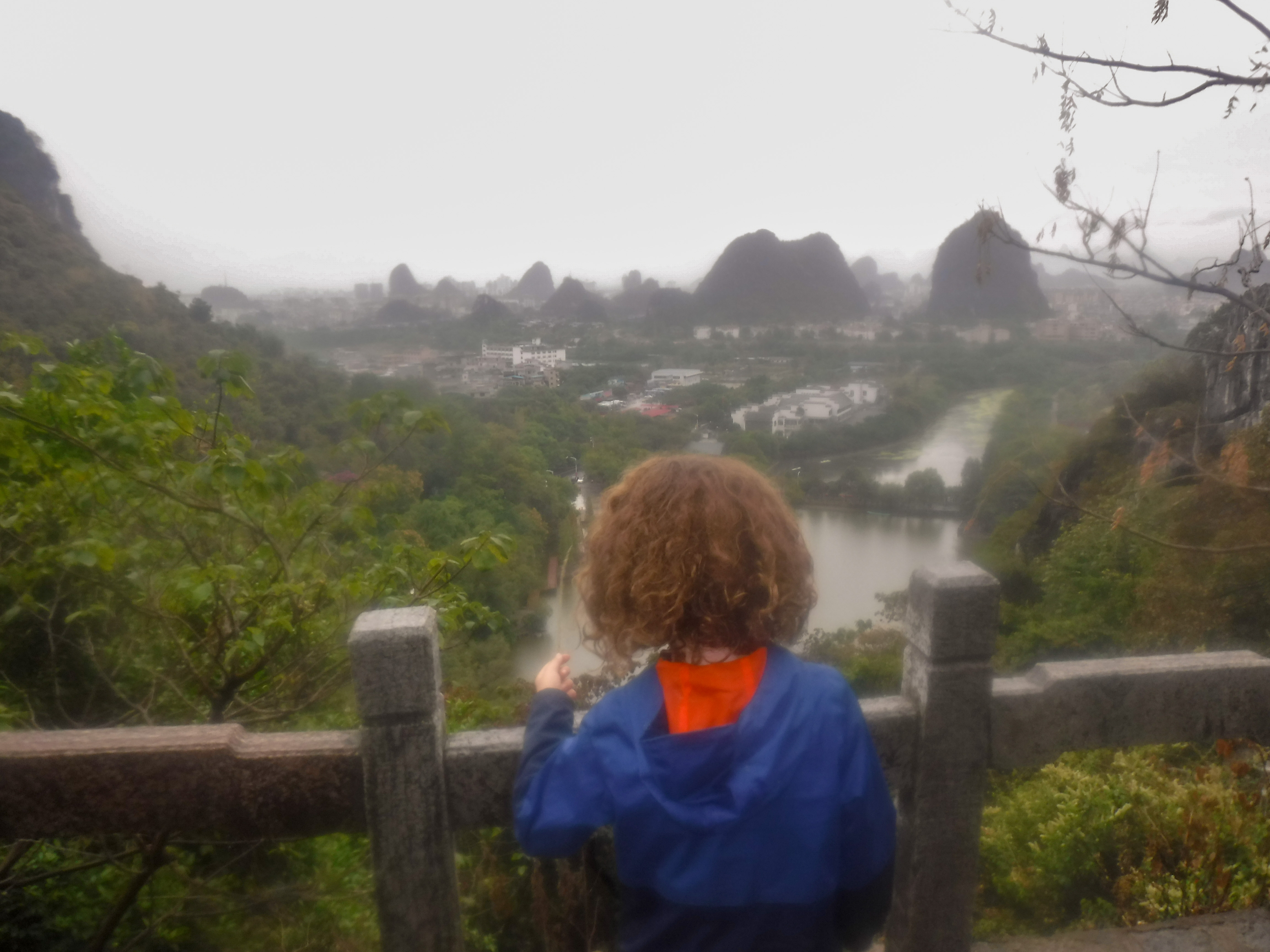 child overlooking Guilin mountains in China