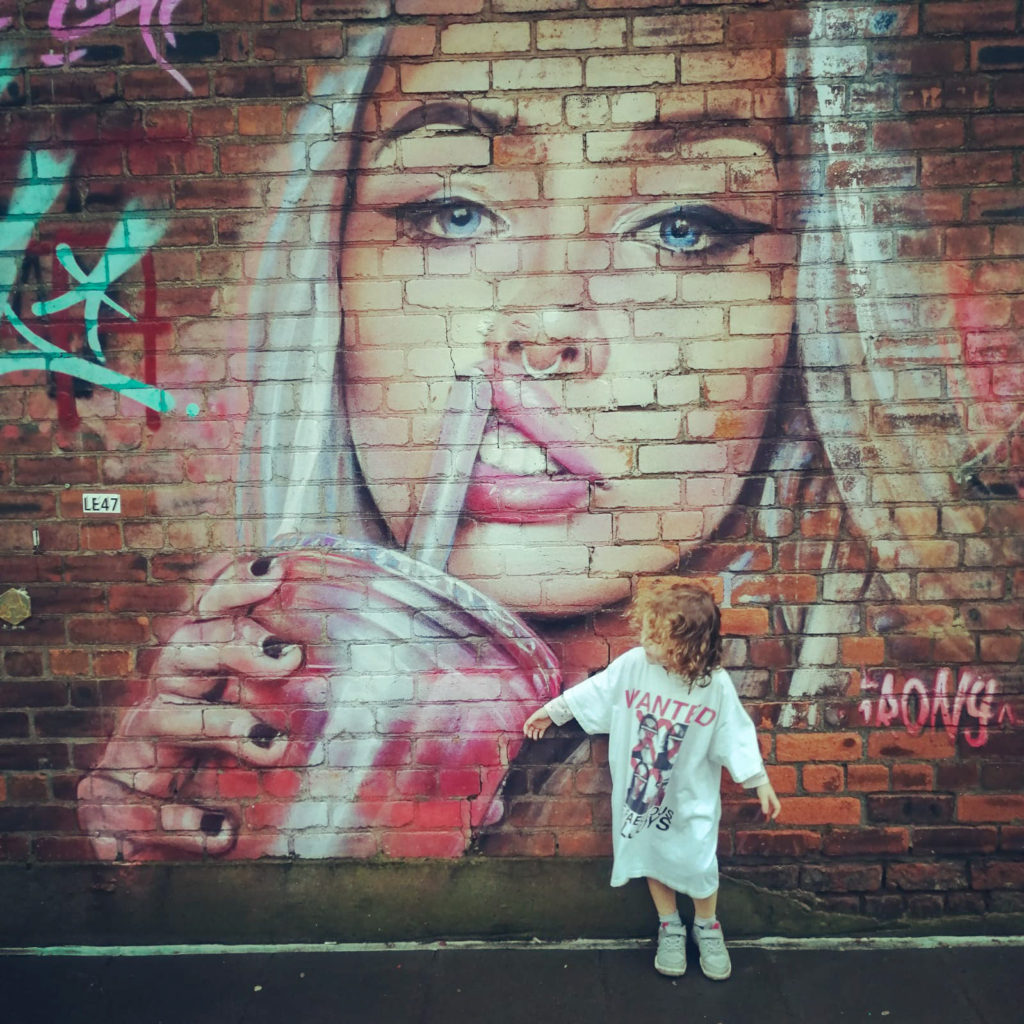 Child in front of Street Art in Liverpool