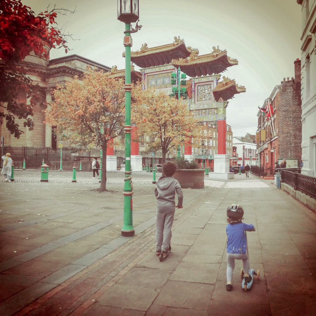 two children in front of Liverpool's Chinese Arch