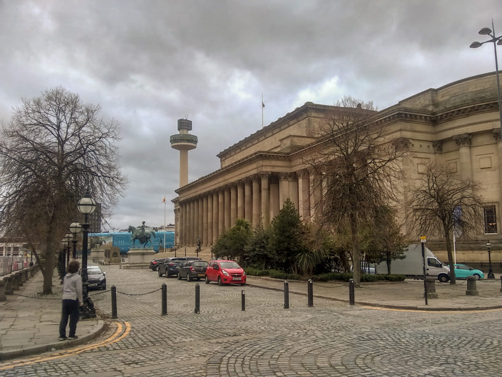 Child in front of St George's Hall and St John's Beacon in Liverpool