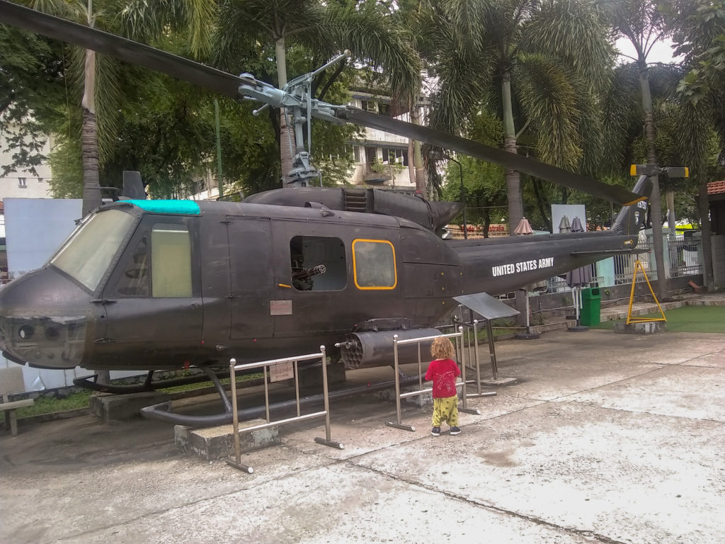 Toddler looking at helicopter at War Remnants Museum in Saigon