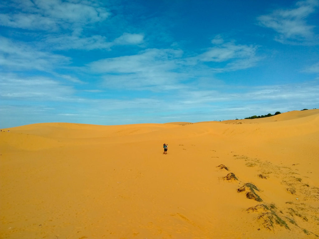 Family stood in red sand dunes in Vietnam