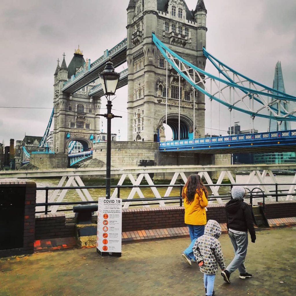 Children walking past Tower Bridge in London