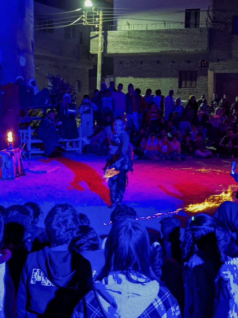community watching a fire show in Luxor, Egypt
