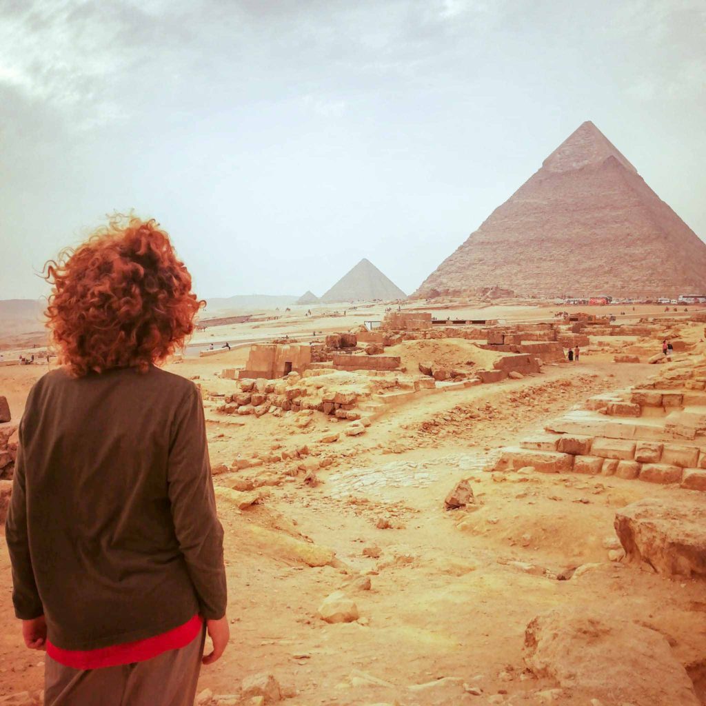 child looking at Great Pyramids of Giza in Egypt