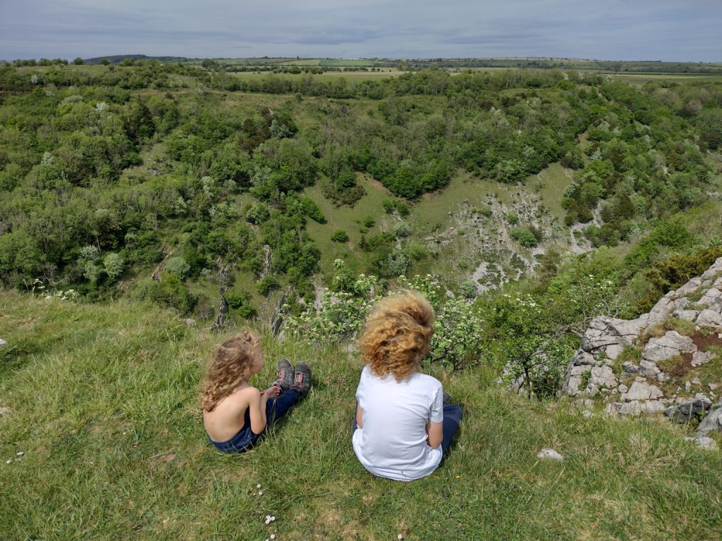 Children sitting on cliff edge at Cheddar Gorge