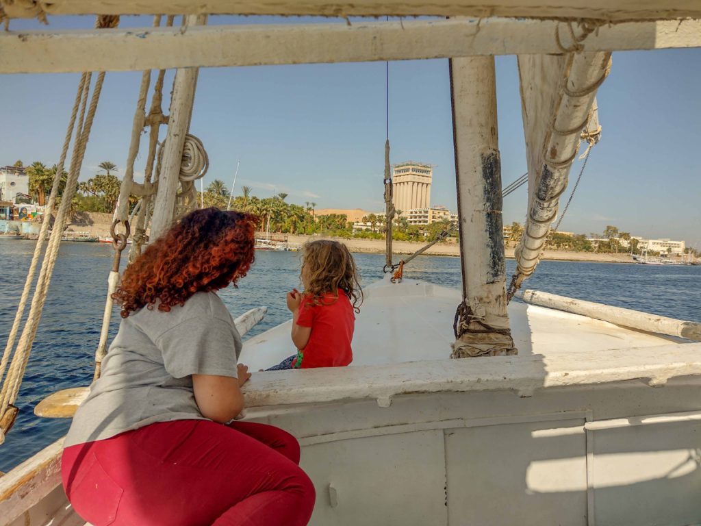 mother and child sat on felucca on River Nile in Egypt