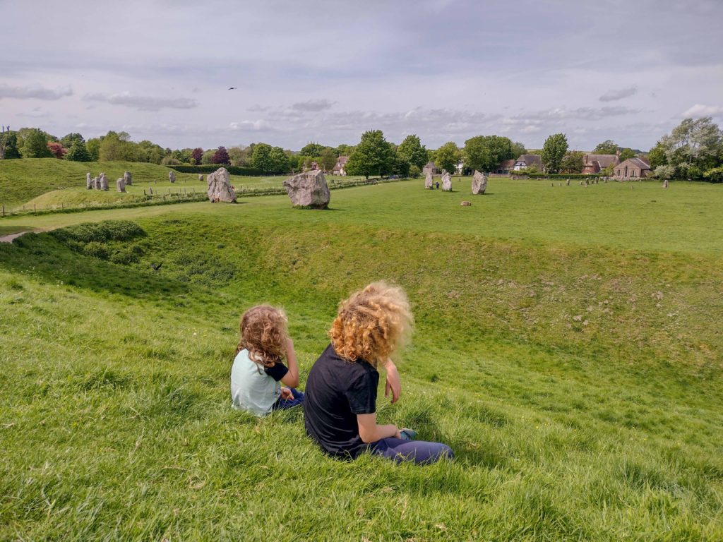 Two children looking at the Avebury Stones