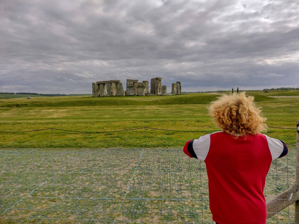 child looking at Stonehenge from public footpath
