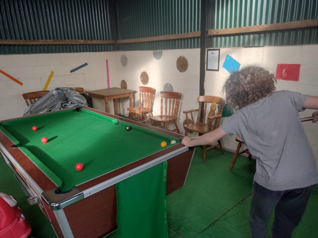 Child playing pool at a campsite in Wales