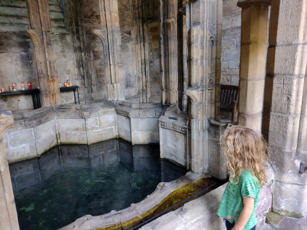 Child looking at St Winefride's Well Shrine in Wales