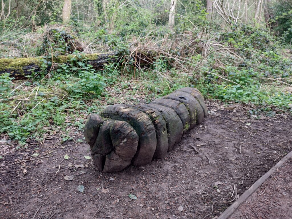 A Caterpillar wood carving at Mosely Bog in Birmingham