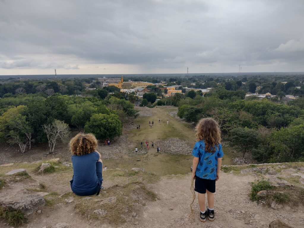 two children overlooking Izamal, Mexico from the top of Piramide Kinich Kakmo
