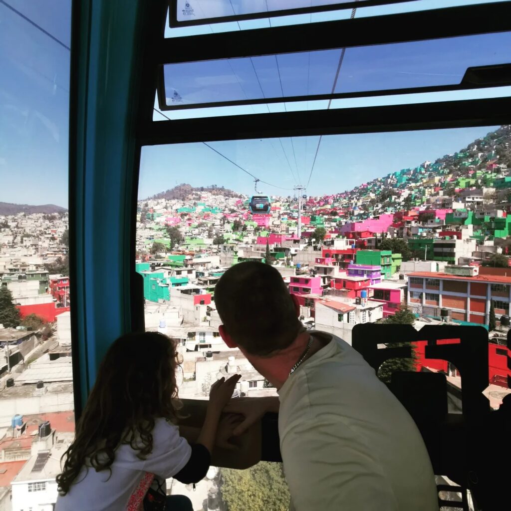 Father and Child Sat in Cable Car overlooking Mexico City