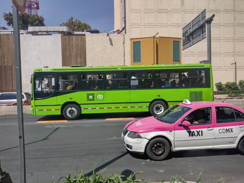 A CDMX Bus and Taxi in Mexico City