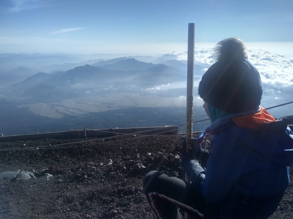 Child sat at summit of Mount Fuji