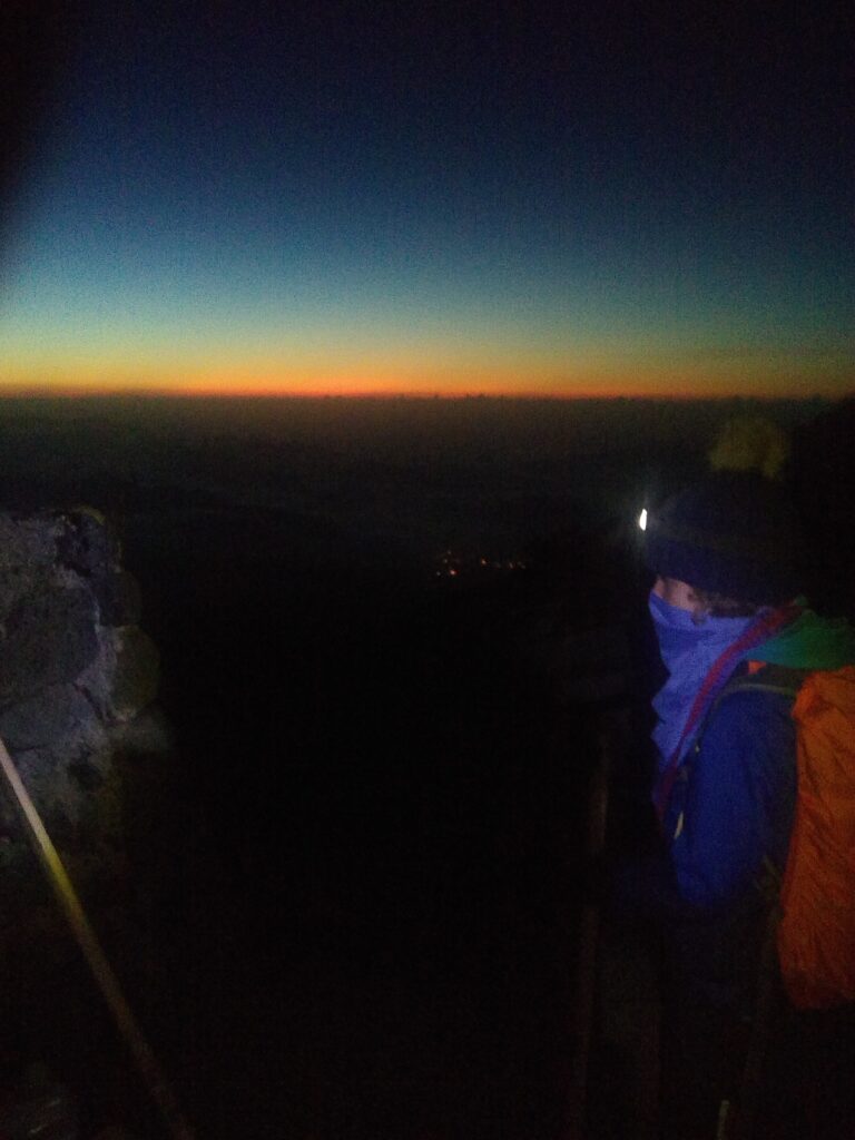 Child in dark on Mt Fuji with head torch on
